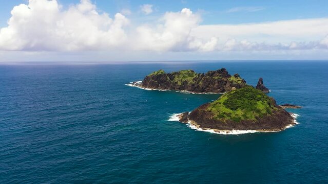 Rocky tropical island in the blue ocean. Dos Hermanos Island. Santa Ana, Cagayan. Philippines.