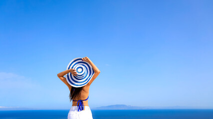 Happy a holiday in Summer blue trend with young woman in hat at happy freedom lifestyle in Aegean...