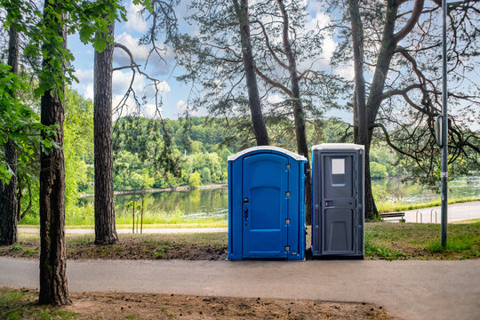 Two portable toilets in a park