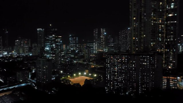Cinematic aerial view of Mumbai's downtown night scene. Central Mumbai's cityscape and skyline- Lalbaug-Parel, Worli, Prabhadevi. beautiful modern buildings, bright glowing lights, and roads.