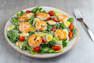 Italian Caesar salad with shrimp, quail eggs, cherry tomatoes, romaine lettuce and parmesan.