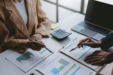 Business people meeting explaining the financial graph data and marketing plan. Group of business...