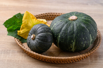 Green pumpkin in basket on wooden background, Organic vegetable