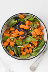  Green salad with sweet potatoes and sesame seeds. Vegan dish. Healthy eating. 