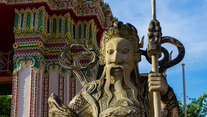 Fototapeta na wymiar Epic warrior statue with moustache in Wat Pho Temple in Bangkok, Thailand.
