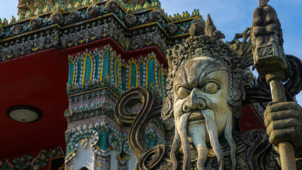 Fototapeta na wymiar Epic warrior statue with moustache in Wat Pho Temple in Bangkok, Thailand.