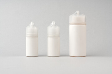 Refill liquid for electronic cigarettes on gray background