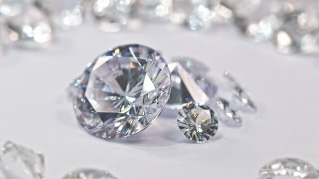 Specially selected white diamonds in a pile of white diamonds..White diamonds of various sizes are placed in a center circle on a white .background surrounded by white diamonds..