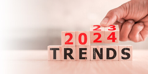 2024 trend concept. Hand flip wood cube change year 2023 to 2024
