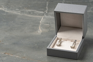 Jewelry box with earrings on a gray background