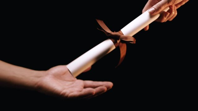 Caucasian Woman Teasing Latino Man Reaching For Diploma. Shot with ARRI Alexa in ArriRaw at 120 fps, exported 23.98 fps QuickTime Apple ProRes 422 HQ.