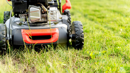 a girl with a lawn mower mows a beautiful lawn