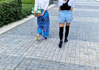 japanese manga style street fashion. comics idols change their dressing styles. girl in long stockings and shorts jeans. navy white t-shirt with ruffles. provocative thigh-high exposed legs