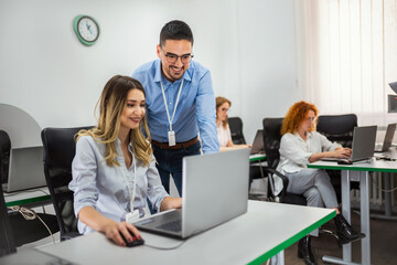 Educator and students in programming school