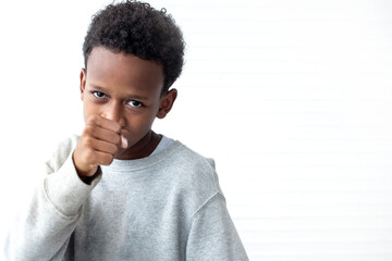 African boy showing fists or boxing on white background, fighting and self defense concept