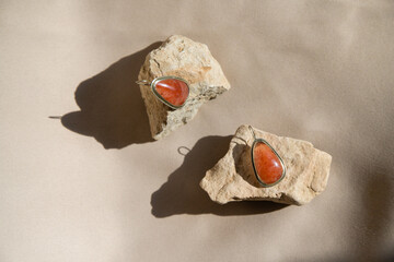 Silver earrings natural sunstone gemstone over  background. - 610891440