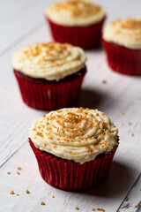 red velvet muffins on a wooden table