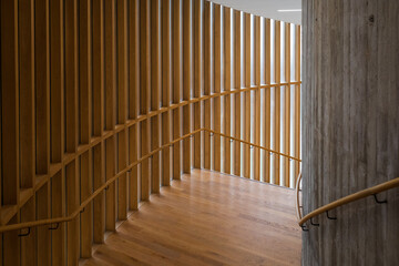 Staircase with wooden paneled wall