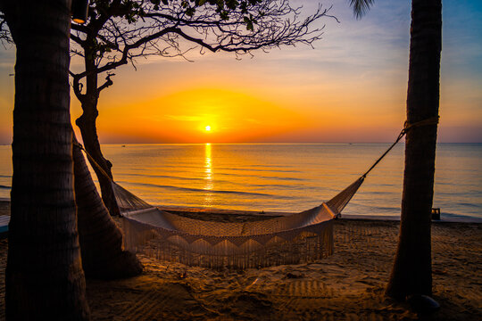 Beachfront sunrise with pool and palm trees in Hua Hin, Prachuap Khiri Khan, Thailand
