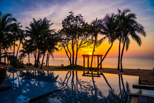 Beachfront sunrise with pool and palm trees in Hua Hin, Prachuap Khiri Khan, Thailand