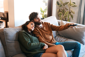 Love, home and relax couple watching tv show, subscription movie or streaming entertainment in living room. Bond, media remote or marriage people watch television, film or video in apartment lounge