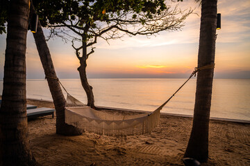 Beachfront sunrise with pool and palm trees in Hua Hin, Prachuap Khiri Khan, Thailand
