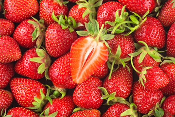 Background of freshly harvested strawberries on flat surface. Food background.