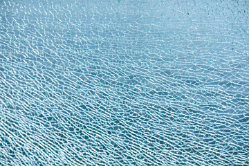 background and texture from fragments of broken glass, blue color