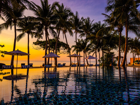 Beachfront sunrise with pool and palm trees in Hua Hin, Prachuap Khiri Khan, Thailand