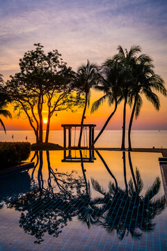 Beachfront sunrise with pool and palm trees in Hua Hin, Prachuap Khiri Khan, Thailand