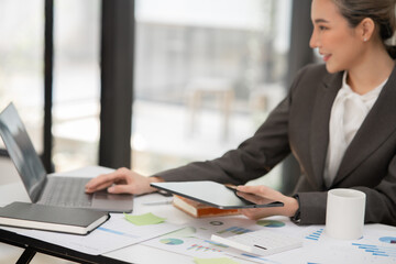 Young Asian businesswoman working on documents at office