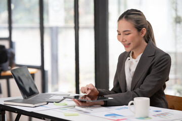 Asian businesswoman working on documents at office