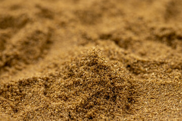 Pile of coriander powder as background, spice or seasoning as background. Close-up coriander powder
