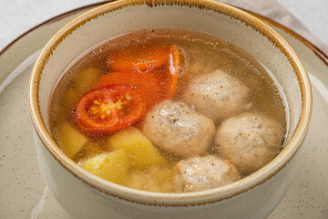 Top view on portion of healthy soup with meatballs