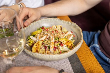 Close up of caesar salad  with apple and pomegranate