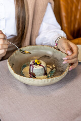 Close up of a woman eating dessert in the restaurant