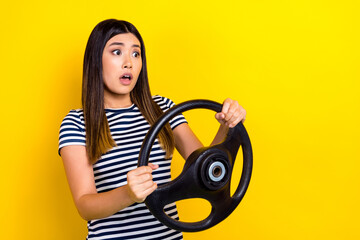 Photo of young scared funny japanese girl hold steering wheel scared nervous stupor road crash accident isolated on yellow color background