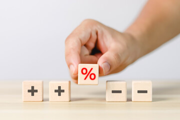 Financial interest rate holding wooden block with percentage sign and up arrow, financial growth, interest rate increase, inflation rate, selling price and tax hike concept and rate simulation	
