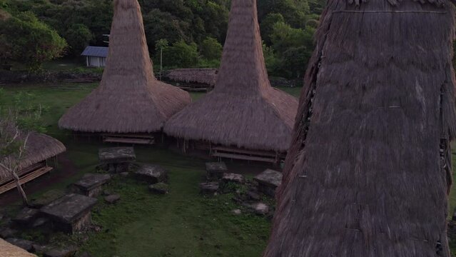 Kampung Adat Ratenggaro during sunrise with grazing horses, aerial