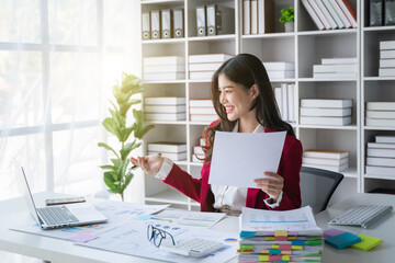 Young Asian business woman employee or executive manager using laptop computer to talking leading hybrid conference remote video call virtual meeting or online training working in office.