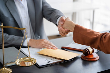 partner lawyers attorneys shaking hands after discussing a contract agreement done.