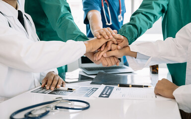 Doctors shaking hands, working together as a team at the hospital.