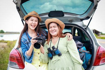 Portrait of two Asian women traveling by private car. Transport concept, tourism. Asian tourists