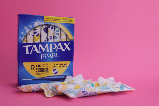 Magdalinovka, Ukraine - June 2, 2023. Tampax pearl tampons personal care products hygiene products, box on pink background