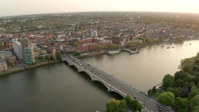 Circling aerial shot around Putney bridge at golden hour