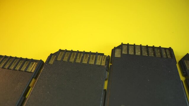 Memory card connectors.in macro, Secure Digital, flash memory card format for use in portable devices isolated and rotating on a black background in slow motion. Macro