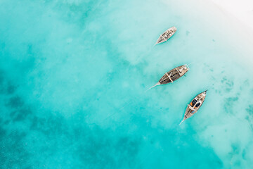 Top view or aerial view of Beautiful crystal clear water and white beach with long tail boats in...