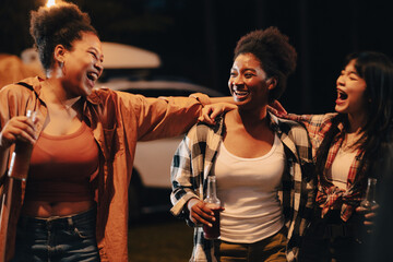 happy young woman friends person having fun to dance in bar-b-q food night party, camp fire friendship group in summer vacation holiday, nature campfire picnic with balefire in evening travel outdoor