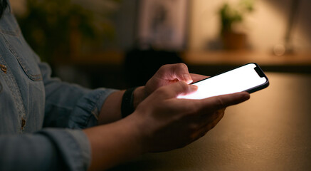 Close Up Of Woman Using Mobile Phone At Home At Night With Illuminated Screen
