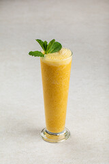 Portion of fresh sweet fruit smoothie with mint